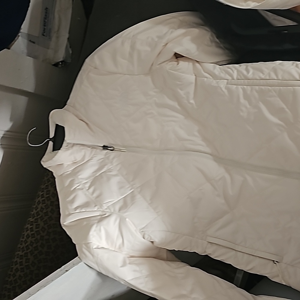 2 white The North Face jackets. One is a small & the other is a Lg. 1 S black
